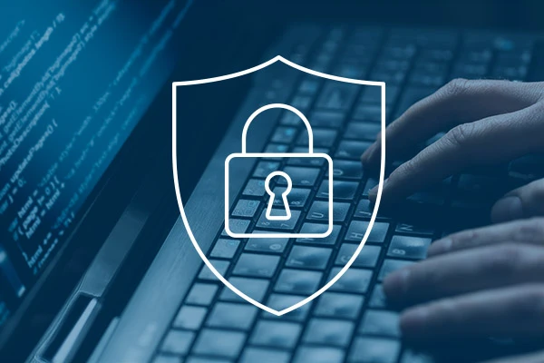 security shield outline over photo of hands at keyboard