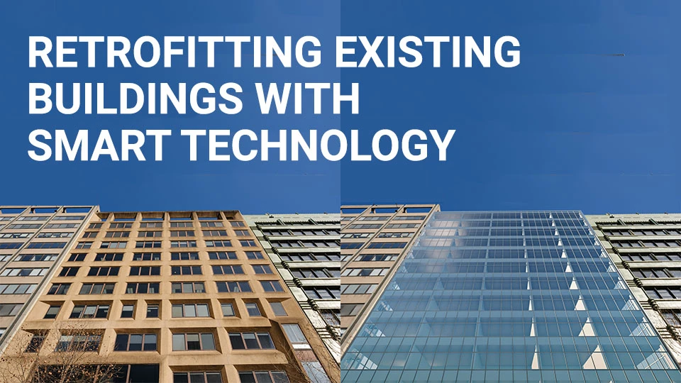 Retrofitting Existing Buildings with Smart Technology blog image of the facade of a tall office building from a "before and after" perspective from street-level view looking up