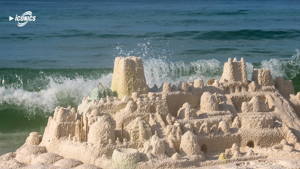 picture of a sandcastle at the shoreline of a beach