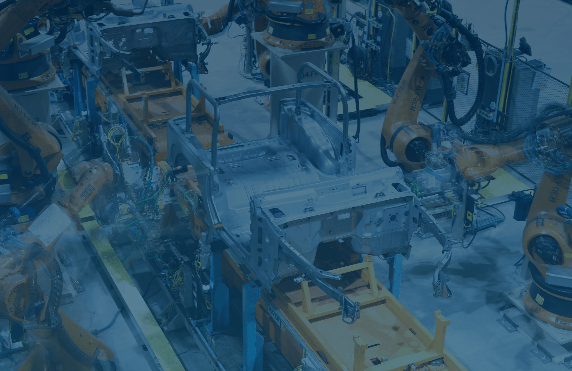 blue tinted photo of overhead view of machine shop
