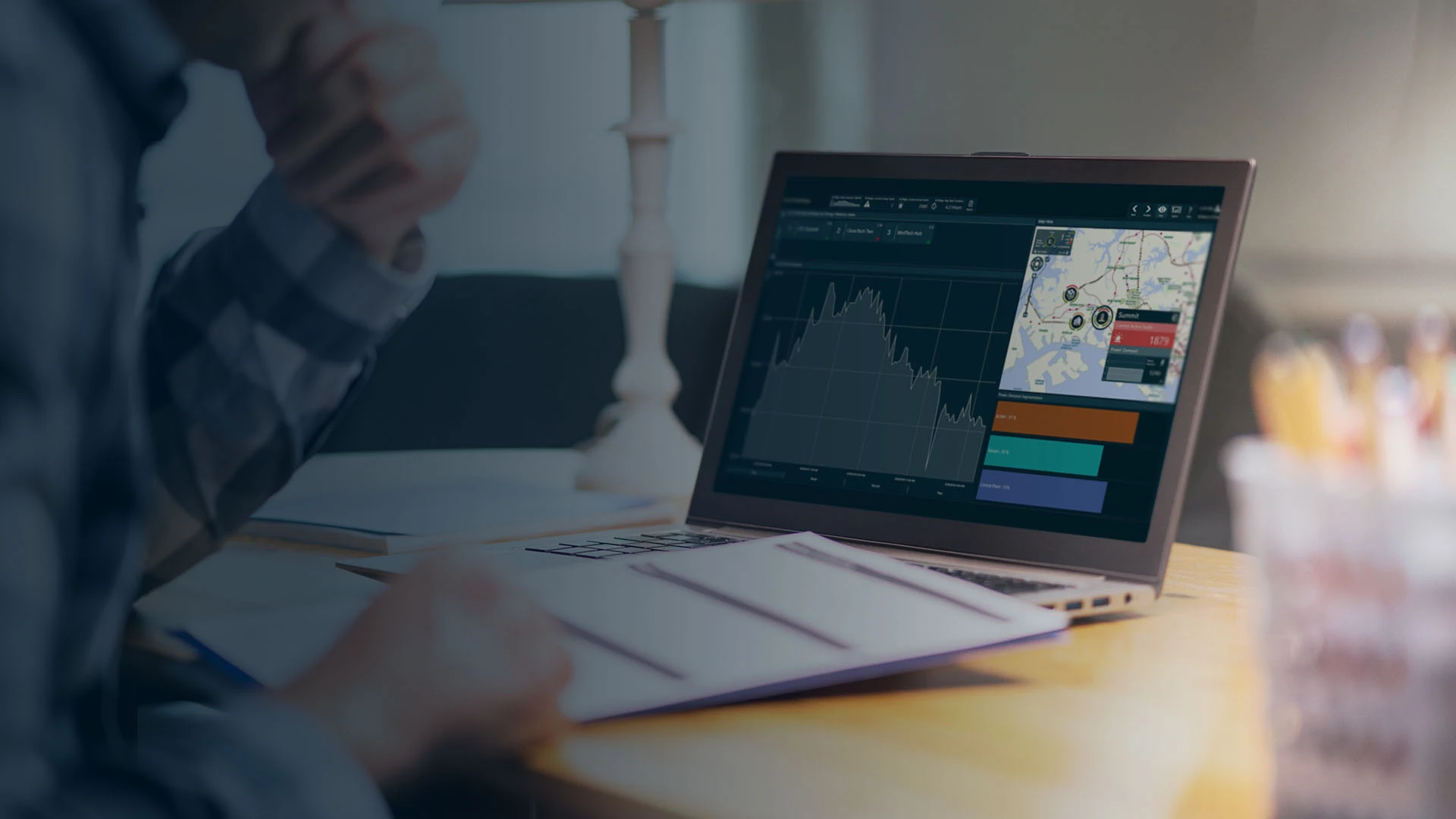 data historian page banner of close-up view of laptop with dashboard view and papers in the foreground